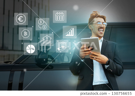 Business professional using technology outdoors while interfacing with financial icons during a daytime event 130756655