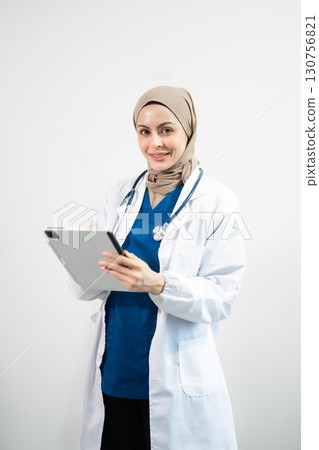 Muslim Arab person. The face of a female doctor on an isolated white background. 130756821