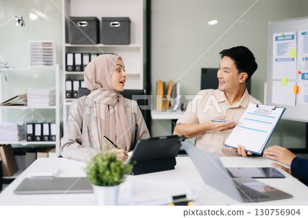 Group of professionals in an office discussing strategy, analyzing data, and collaborating on projects 130756904