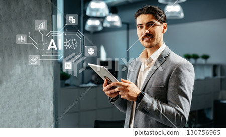 Man in business attire engages with technology, exploring artificial intelligence concepts in a modern office setting 130756965