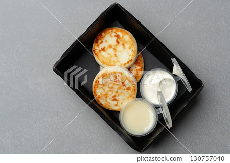 Delicious traditional flatbreads served with creamy dips in a simple black tray 130757040