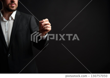 Hand gesturing signifying a presentation or speech while wearing a suit in a professional setting at night 130757050