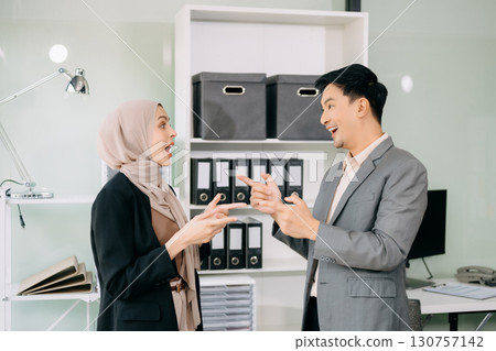 Businesswoman leading team meeting and using tablet and laptop computer with financial Businesswoman leading team meeting and using tablet and laptop computer with financial 130757142
