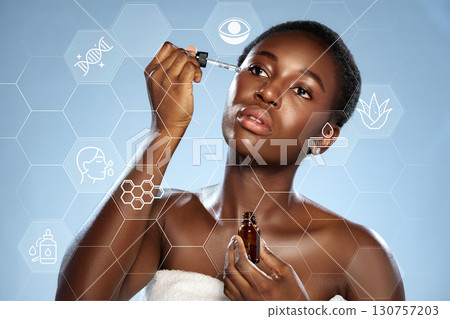 Woman applying skincare serum with graphics of beauty ingredients and benefits in a bright setting 130757203