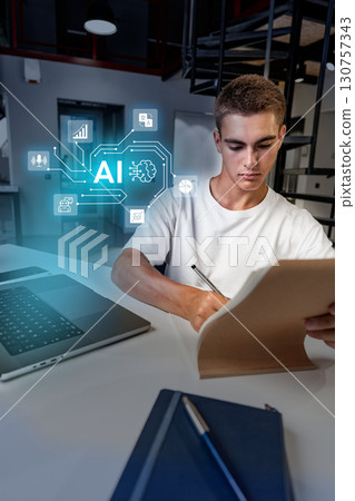 Young man applying artificial intelligence concepts while studying in a modern workspace during daylight hours 130757343