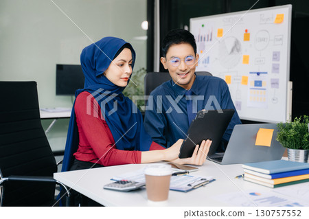 Group of professionals in an office discussing strategy, analyzing data, and collaborating on projects Group of professionals in an office discussing strategy, analyzing data, and collaborating on projects 130757552