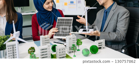 Business people having consultation about wind energy at company office. Business team discussing about windmill and alternative green enery. Executive meeting 130757862