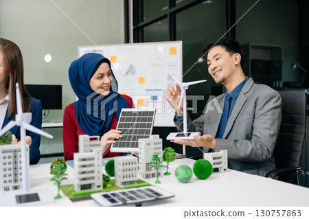 Business people having consultation about wind energy at company office. Business team discussing about windmill and alternative green enery. Executive meeting 130757863