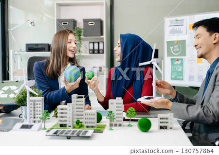 Business people having consultation about wind energy at company office. Business team discussing about windmill and alternative green enery. Executive meeting Business people having consultation about wind energy at company office. Business team discussing about windmill and alternative green enery. Executive meeting 130757864