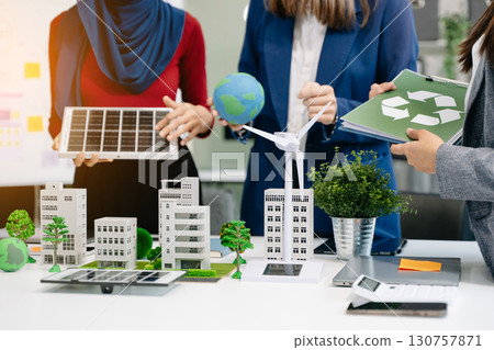 business team people planning and discussing on recycle reduce reuse policy symbol in office meeting room. Green business company and Solar Energy Environment city business team people planning and discussing on recycle reduce reuse policy symbol in office meeting room. Green business company and Solar Energy Environment city 130757871