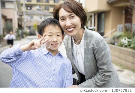 Parent and child cuddling with a smile Parent and child cuddling with a smile 130757931