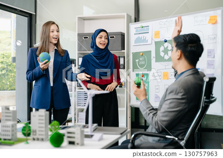 Business people having consultation about wind energy at company office. Business team discussing about windmill and alternative green enery. Net zero and carbon neutral Business people having consultation about wind energy at company office. Business team discussing about windmill and alternative green enery. Net zero and carbon neutral 130757963