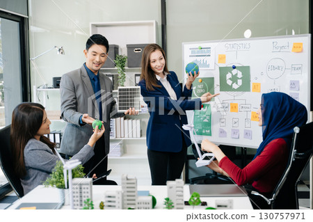 Business people having consultation about wind energy at company office. Business team discussing about windmill and alternative green enery. Net zero and carbon neutral 130757971