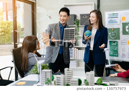 Business people having consultation about wind energy at company office. Business team discussing about windmill and alternative green enery. Net zero and carbon neutral 130757973