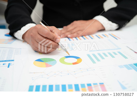 Asian business woman working with financial graph. Asian business woman working with financial graph. 130758027