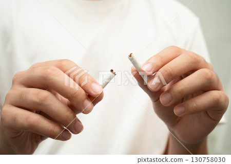 Quit smoking, Asian teenage man breaking destroy cigarette in hand. Quit smoking, Asian teenage man breaking destroy cigarette in hand. 130758030