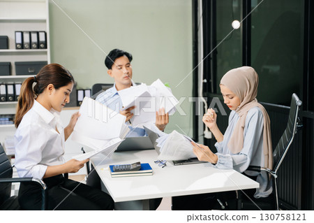 Asian businesspeople while collaborating on a new project. using a laptop and tablet Asian businesspeople while collaborating on a new project. using a laptop and tablet 130758121