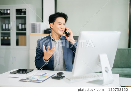 Asian businessman are delighted and happy with the work they do on their tablet, laptop and taking notes Asian businessman are delighted and happy with the work they do on their tablet, laptop and taking notes 130758160