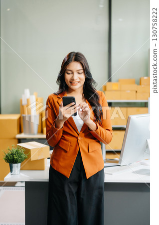 Startup small business SME, Entrepreneur owner woman using smartphone or tablet taking receive and checking 130758222