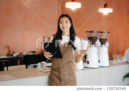 Startup successful small business owner sme woman stand with tablet  in cafe 130758340