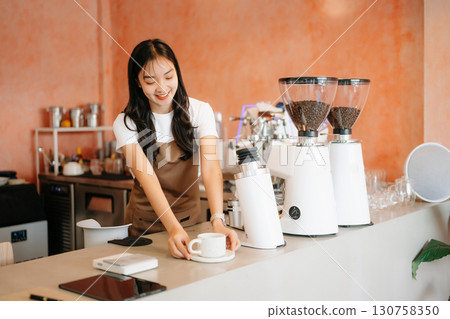 Explore professional Asian baristas brewing coffee, using notepads, digital tablets, and showcasing coffee Explore professional Asian baristas brewing coffee, using notepads, digital tablets, and showcasing coffee 130758350