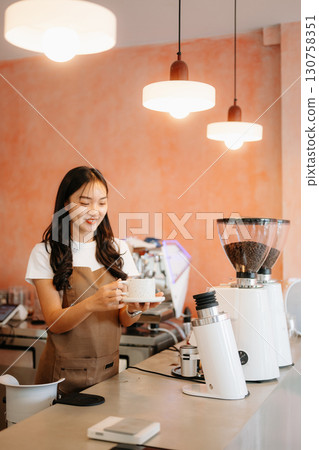 Explore professional Asian baristas brewing coffee, using notepads, digital tablets, and showcasing coffee Explore professional Asian baristas brewing coffee, using notepads, digital tablets, and showcasing coffee 130758351