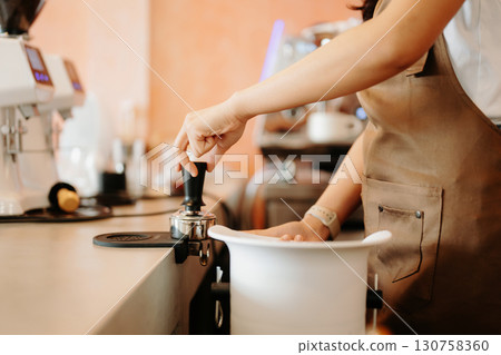 Explore professional Asian baristas brewing coffee, using notepads, digital tablets, and showcasing coffee Explore professional Asian baristas brewing coffee, using notepads, digital tablets, and showcasing coffee 130758360