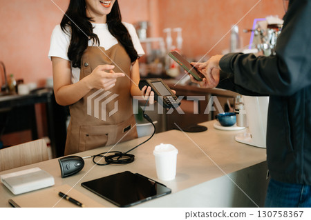 waitress with pos at coffee shop with sale, deal and fintech for customer experience. People, service and payment 130758367
