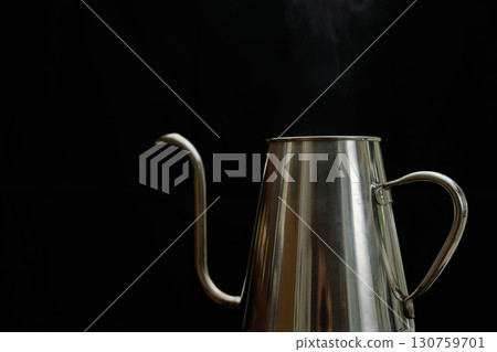 Steam rising from a drip kettle with boiling water. A series of steps in brewing coffee with a paper drip. 130759701