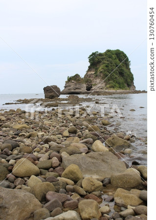 A small island that can be reached at low tide 130760454