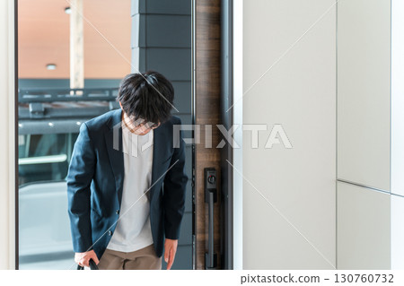 A businessman in a jacket greeting at the entrance 130760732