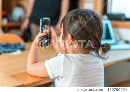 A girl watching anime and videos on her smartphone 130760904