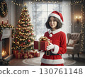 Girl in Santa costume holding Christmas gift 130761148