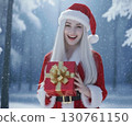 Smiling woman in Santa costume holding a gift 130761150