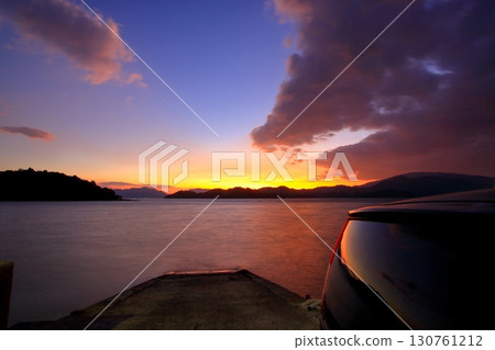 Park your car and look out at the sea at sunset 130761212