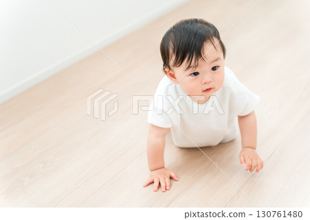 Baby crawling in the living room at home Baby crawling in the living room at home 130761480