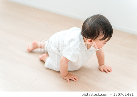 Baby crawling in the living room at home Baby crawling in the living room at home 130761481