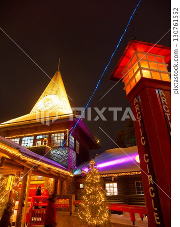 Illuminated Santa Claus Village at night and the blue line marking the Arctic Circle 130761552