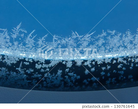 Airplane window with snowflakes 130761645