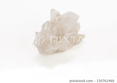 Natural quartz crystal cluster on a white background Natural quartz crystal cluster on a white background 130762468