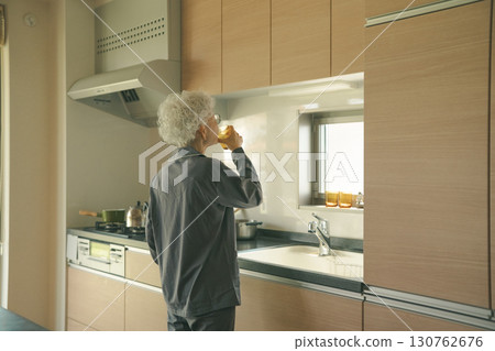 Elderly people drinking water in the kitchen as soon as they wake up Elderly people drinking water in the kitchen as soon as they wake up 130762676