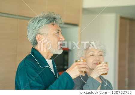Elderly couple drinking water in the morning Elderly couple drinking water in the morning 130762732