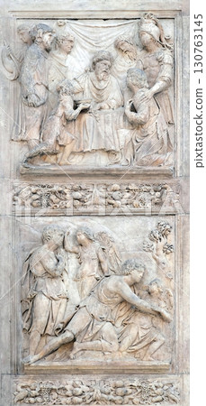 Jacob and the Angel by Niccolo Tribolo up and Benjamin brings the cup to Pharaoh by Francesco da Milano, left door of San Petronio Basilica in Bologna, Italy 130763145