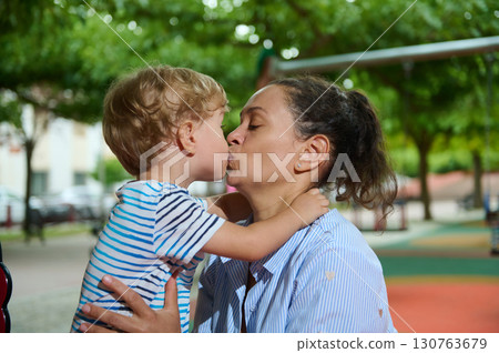 Joyful Moment Between Parent and Child at a Park Playground Joyful Moment Between Parent and Child at a Park Playground 130763679