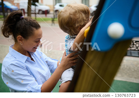 Mother and Child Enjoy Quality Time at the Playground Outdoors 130763723