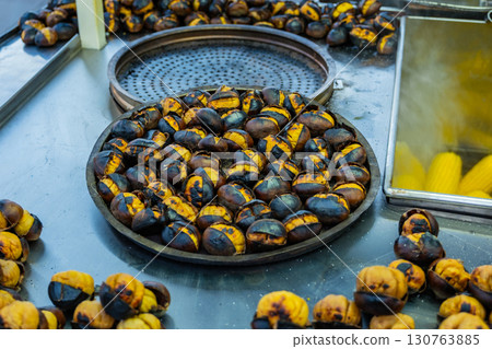 Fresh fried chestnuts on the streets of Istanbul. Turkish street food. Fast food. National cuisine Fresh fried chestnuts on the streets of Istanbul. Turkish street food. Fast food. National cuisine 130763885