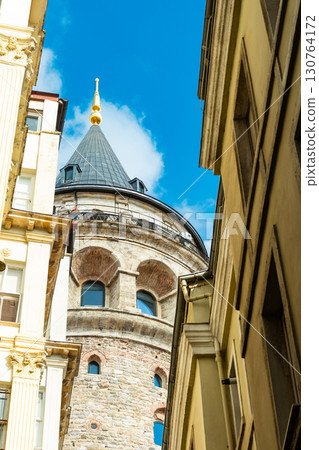 Istanbul, Turkey. View of Galata tower through the streets with tight buildings. Travel attraction. Islamic architecture Istanbul, Turkey. View of Galata tower through the streets with tight buildings. Travel attraction. Islamic architecture 130764172