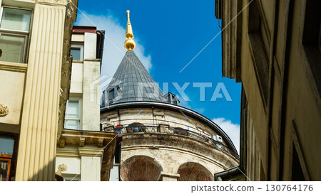 Istanbul, Turkey. View of Galata tower through the streets with tight buildings. Travel attraction. Islamic architecture Istanbul, Turkey. View of Galata tower through the streets with tight buildings. Travel attraction. Islamic architecture 130764176