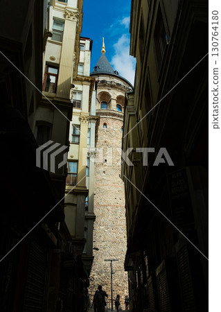 Istanbul, Turkey. View of Galata tower through the streets with tight buildings. Travel attraction. Islamic architecture Istanbul, Turkey. View of Galata tower through the streets with tight buildings. Travel attraction. Islamic architecture 130764180