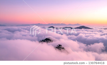 A sea of clouds bathed in pink at dawn 130764418